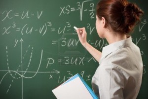 7042592-girl-writing-the-mathematical-formulas-on-a-chalkboard